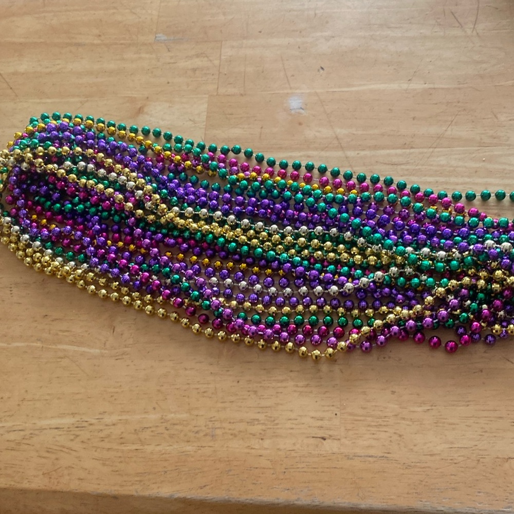 14 strands of Mardi Gras beads. Gold purple green and pink as shown